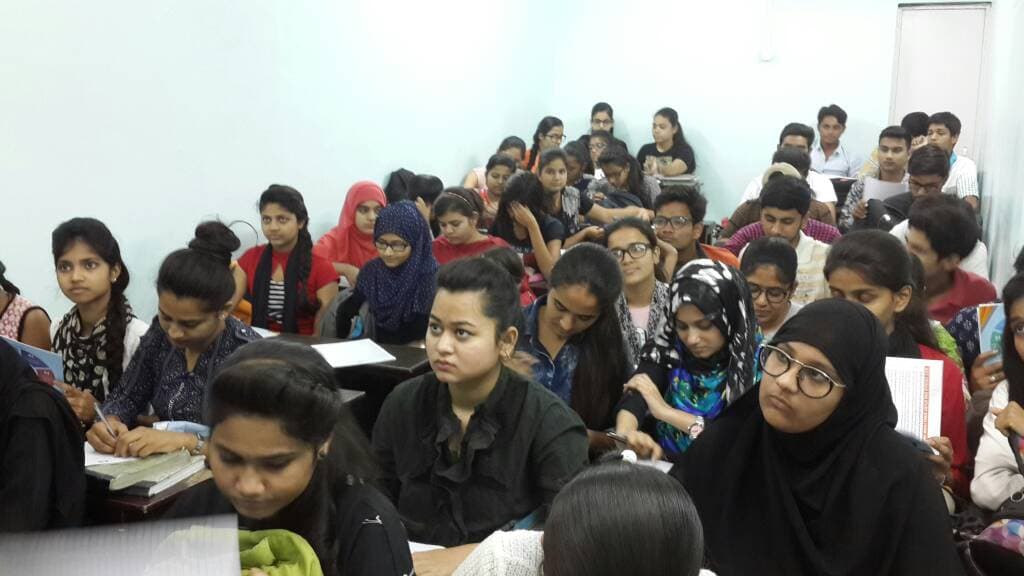 A crowded classroom of students taking notes during a session